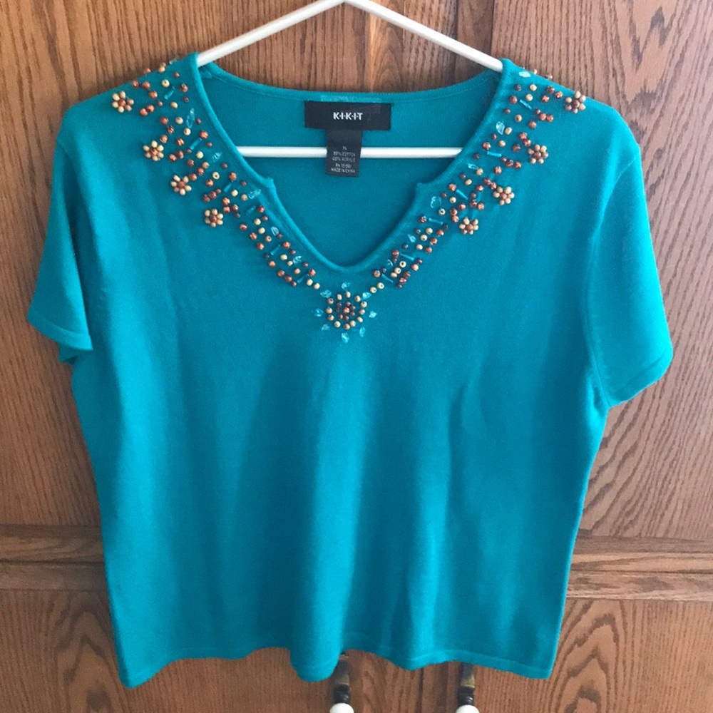 Teal blue knit top with beaded neckline